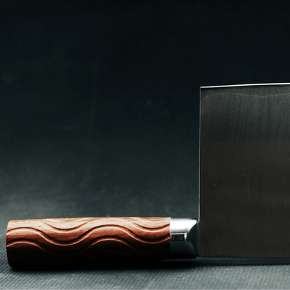 Rosewood handle with intricate wave pattern on a dark background.