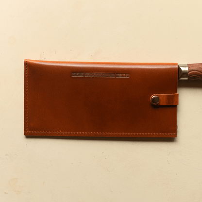 Brown leather sheath with a silver clasp on a beige background
